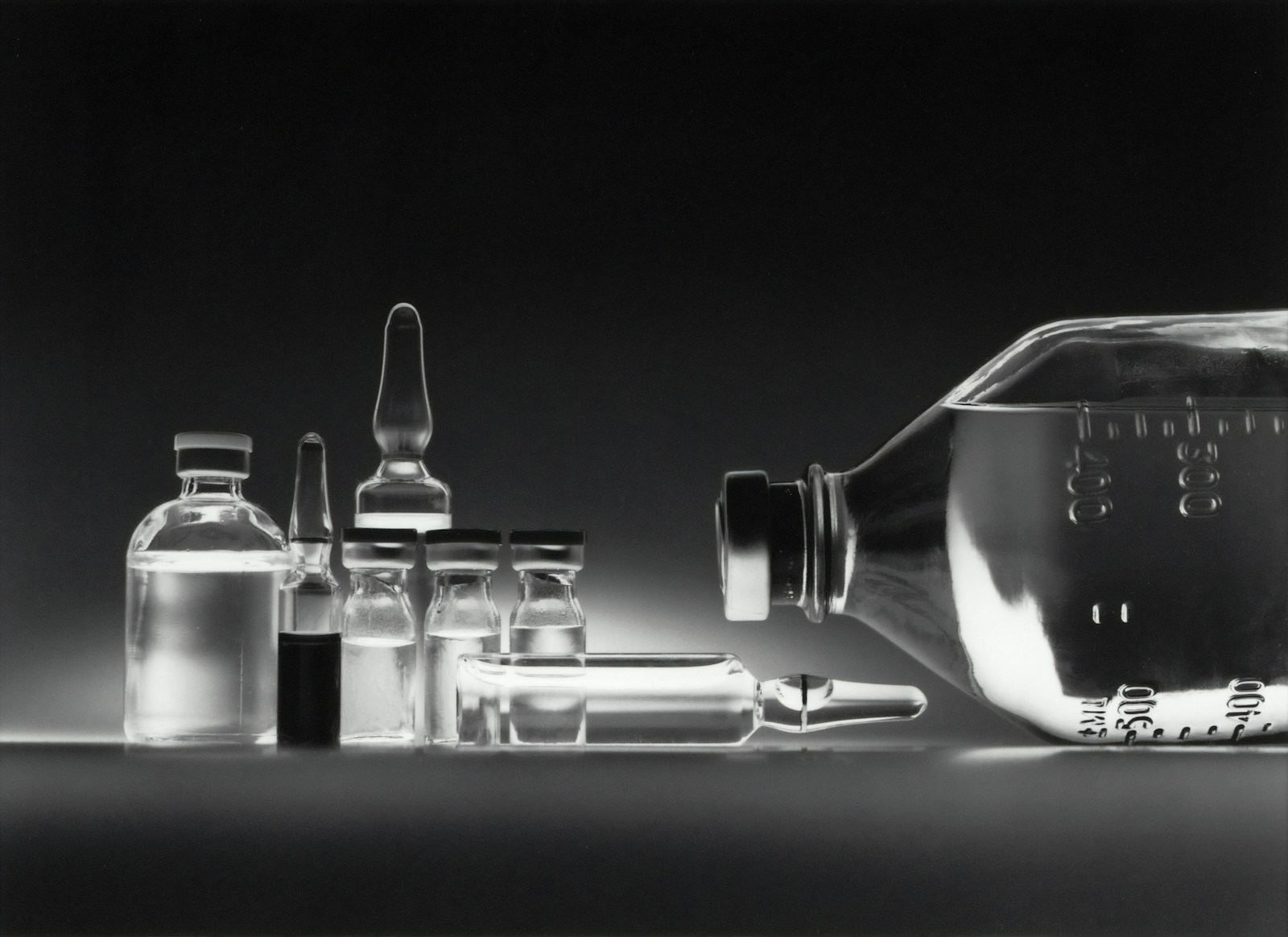 Laboratory sample vials arranged in dark, cinematic lighting